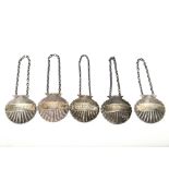 Five silver decanter labels, each of cast scallop shell form, comprising; Brandy, Whisky and Gin,