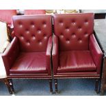 A pair of George III style square back armchairs with studded faux red leather upholstery on turned