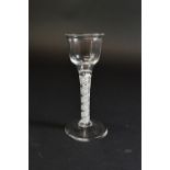 A near pair of opaque twist wine glasses, circa 1760, each with ogee bowl,