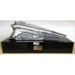 An Art Deco style white metal train raised on a black polished marble plinth with applied
