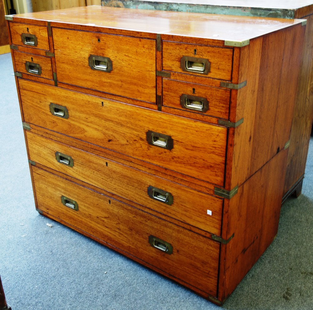 A 19th century teak two part campaign chest on five short over three long drawers,