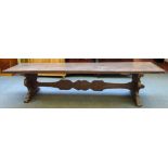 A 17th century style Italian walnut refectory table on trestle end standards,