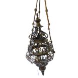 A Persian style patinated brass hanging lantern with pierced shaped body, 70cm.