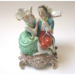 A Herend porcelain figural spill vase modelled with a gallant and companion beneath two foliate