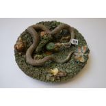 A Palissy style pottery charger, late 19th century, typically decorated in high relief with lizards,