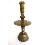 A large Dutch East Indies brass candlestick of turned tapering form, 59cm high,