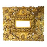 A 19th century European profusely carved gilt picture frame, 64cm wide x 53cm high.