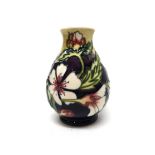 A Moorcroft 'Comfrey' vase, circa 1995, purple/cream ground, 14cm high, boxed.