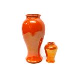 A small Moorcroft orange lustre vase, circa 1916, 9.5cm high, and one larger lustre vase (2).