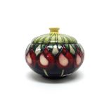 A Moorcroft 'April Tulip' bowl and cover by Emma Bossons, circa 2002, 13.5cm diameter, boxed.