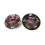 Two Moorcroft 'Anemone' green ground shallow bowls, mid 20th century, 14cm diameter (2).