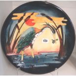 A Moorcroft heron design 'Reeds at Sunset' charger, circa 1990, 35cm diameter, boxed.