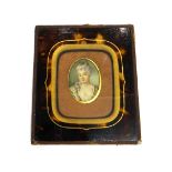 An oval portrait miniature of a lady, in 18th century dress,