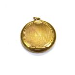 A lady's 9ct gold circular pendant powder compact, with engine turned decoration,