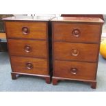 A pair of mahogany three drawer bedside cabinets, each with routed bun handles, 61cm wide.