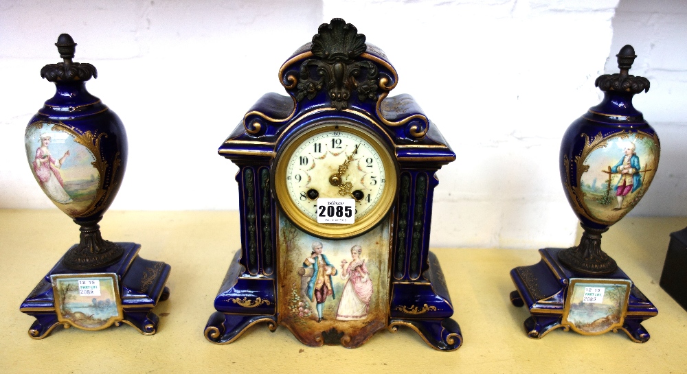 A three piece pottery blue glaze and painted clock garniture,