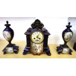 A three piece pottery blue glaze and painted clock garniture,