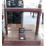 A 19th century oak and mahogany table top book press with wooden worm, 42cm wide.