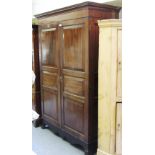 A George III mahogany Jersey hanging cupboard, with pair of six panel doors on splayed bracket feet,