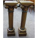 A pair of 20th century gilt painted corinthian columns on stepped square bases, each 81cm high.