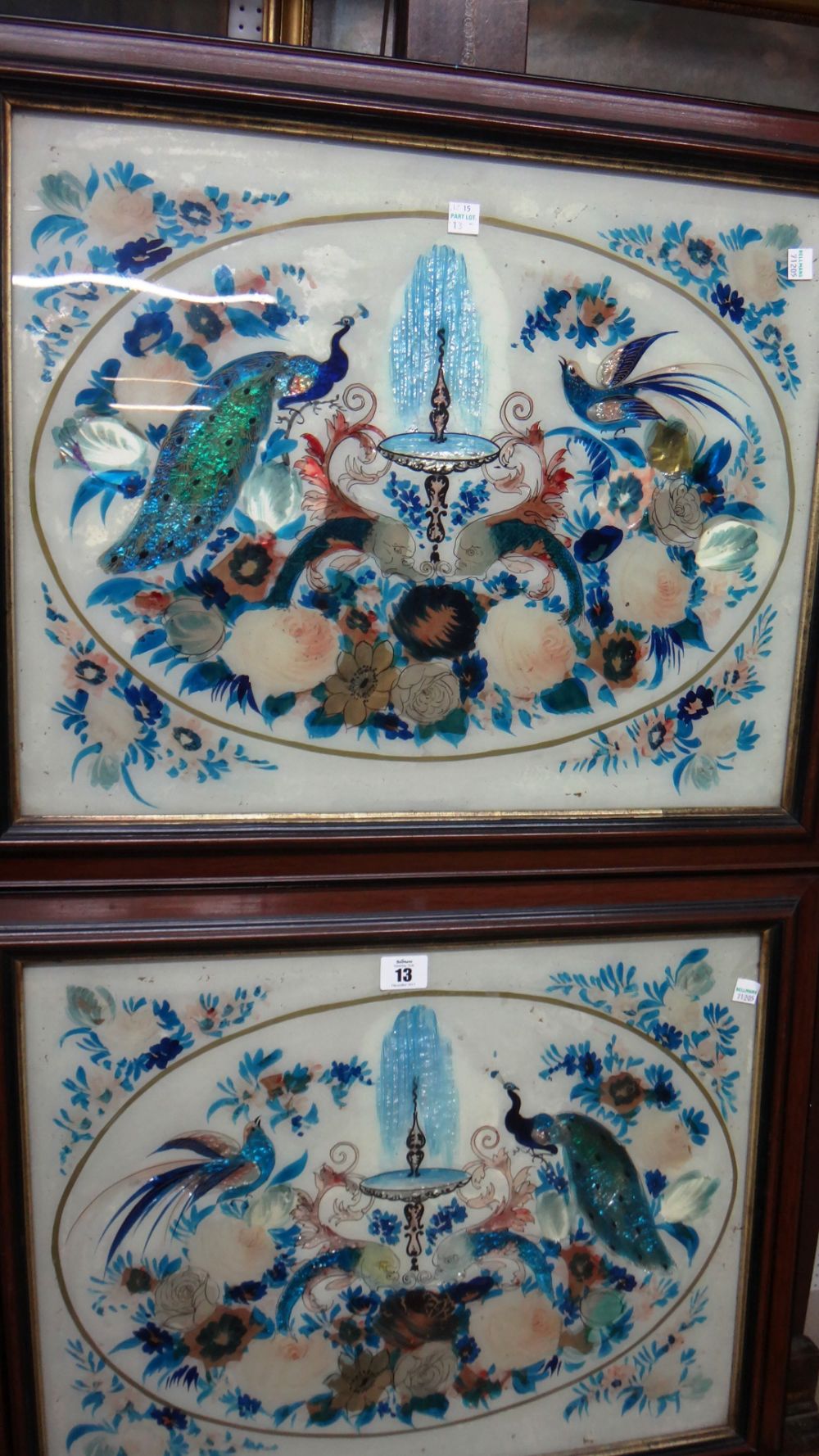 A pair of late 19th century reverse painted and foil pictures on glass, depicting birds,