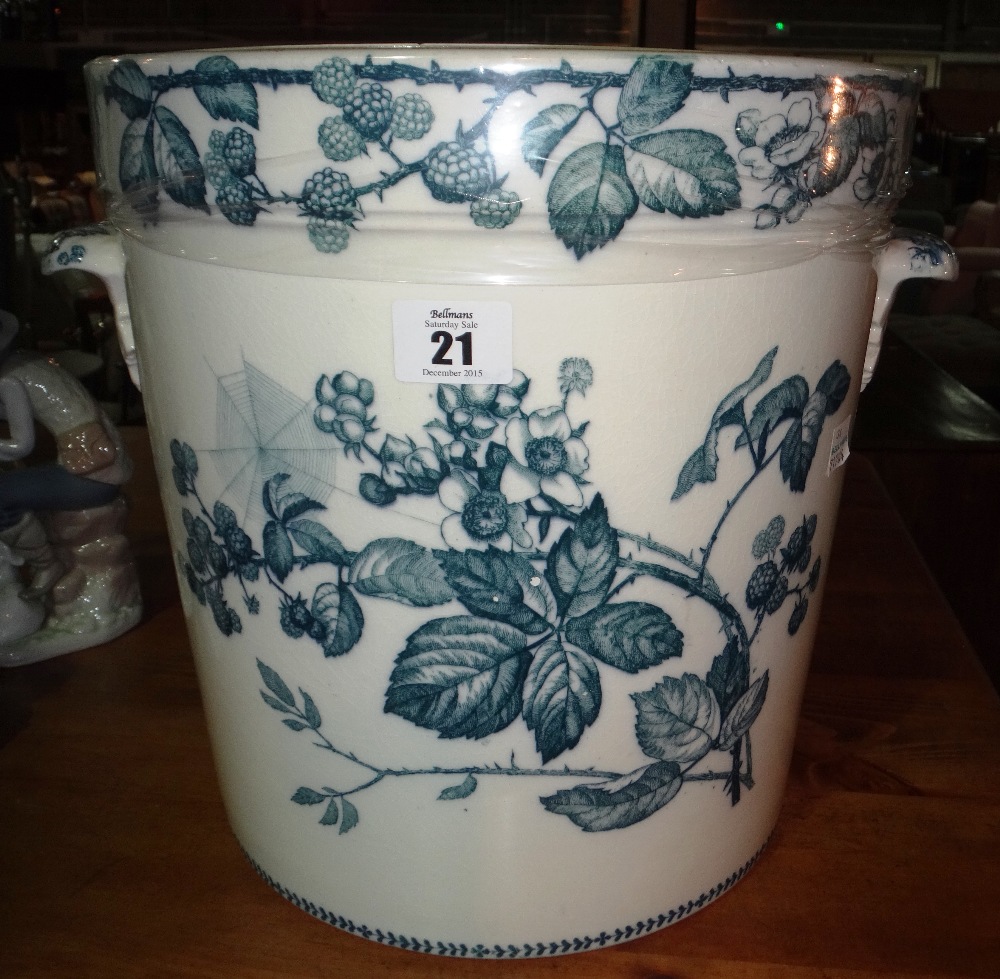 A Victorian white glazed ceramic chamber pot and a painted jardiniere stand.