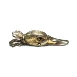 A plated letter clip, formed as the head of a duck, with boot button eyes.