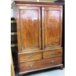 A George III mahogany linen press, the pair of panel doors over two short and three long drawers,