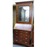 A small George III mahogany bureau bookcase, the single mirror door over a fitted interior,