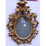 A small early 20th century oval gilt framed mirror with acanthus scroll decoration,