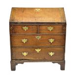 A small 18th century oak bureau, the fitted interior over two short and two long drawers,