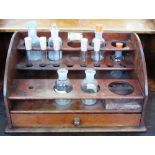 A late 19th century mahogany apothecary stand for eight bottles and eight vials,