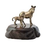 A Zimbabwean model of a baby zebra with its mother, on an oval stand, by Patrick Mavros.