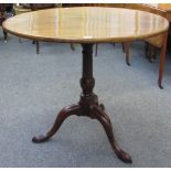 A George III mahogany occasional table, the oval snap top on tripod base, 83cm wide x 71cm high.