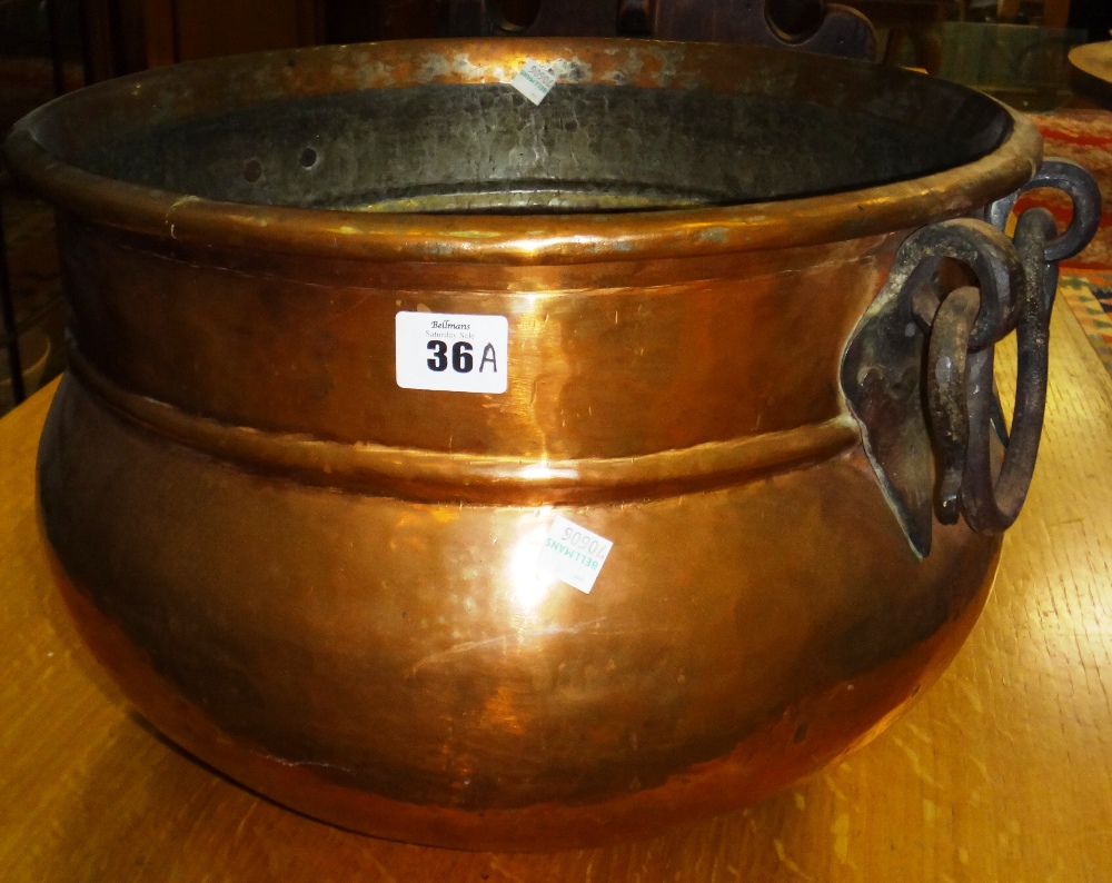 A 19th century twin handled copper cauldron.