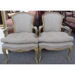 A pair of green painted Louis XV style fauteuils, with floral carved crest rail and serpentine seat,