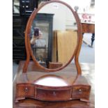 An early 19th century inlaid mahogany toilet mirror with serpentine three drawer base,