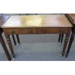 A 19th century mahogany two drawer writing table on turned supports, 105cm wide.