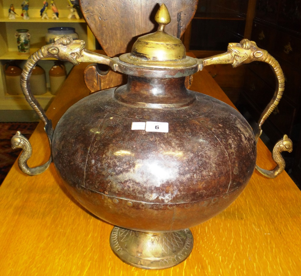 A twin handled metal urn and an embossed brass coal bucket.