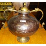 A twin handled metal urn and an embossed brass coal bucket.