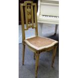 A pair of early 20th century cream painted parcel gilt side chairs, with urn splat and cane seat,