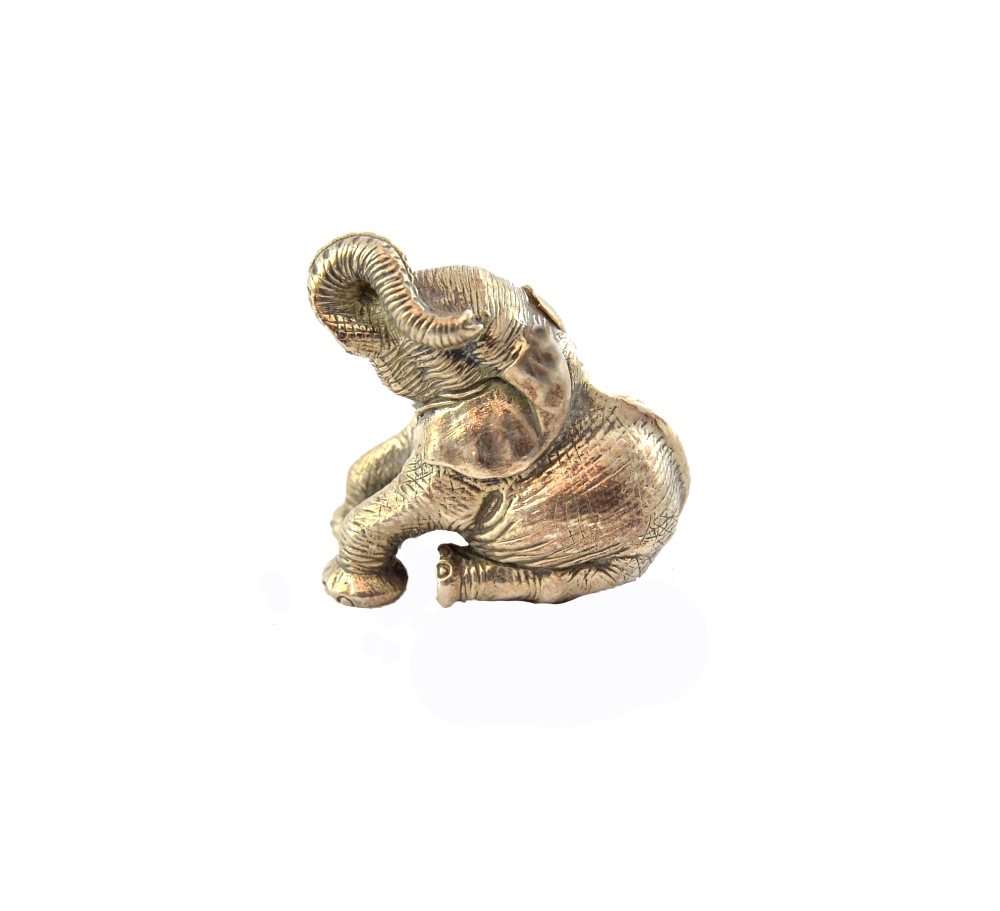 A Zimbabwean model of a seated baby elephant, by Patrick Mavros, weight 66 gms.
