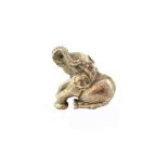 A Zimbabwean model of a seated baby elephant, by Patrick Mavros, weight 66 gms.