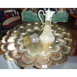 An Eastern embossed brass tray, another similar, a claret jug and a pair of opera glasses.