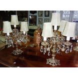 A pair of gilt brass five branch lustre table lamps.