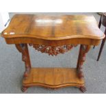 A 19th century Continental walnut serpentine console table on scroll supports united by platform