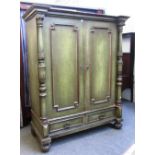 A 19th century green painted Continental two door armoire, with turned columns and two drawer base,