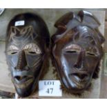 Two African carved masks with copper wor