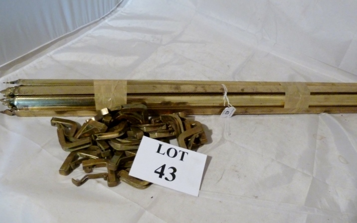 A set of 13 brass stair rods with clips