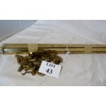 A set of 13 brass stair rods with clips